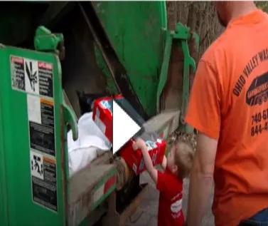 A man and child looking at the trash.