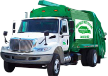 A green and white truck is parked in the dark.